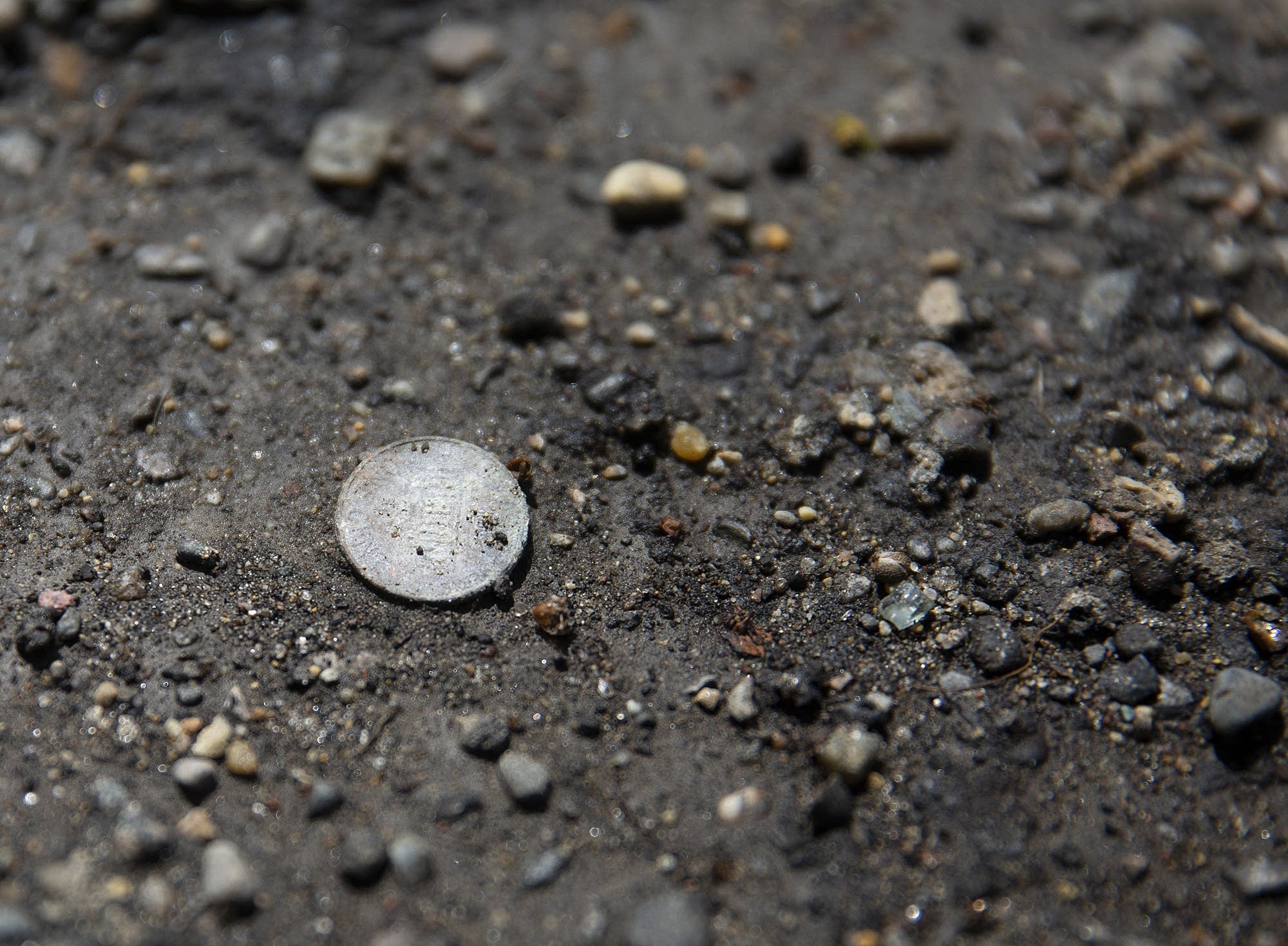 A penny sits on the ground at a trailer where a girl choked to death.