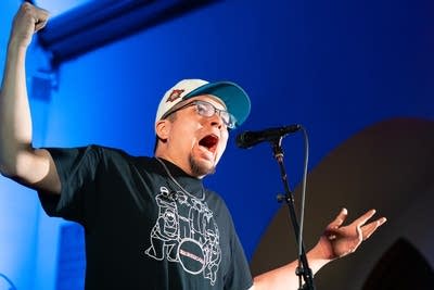 Man singing with arms open