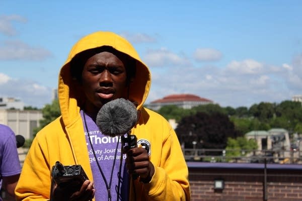 Radio Camp reporter Datelle Straub holds equipment