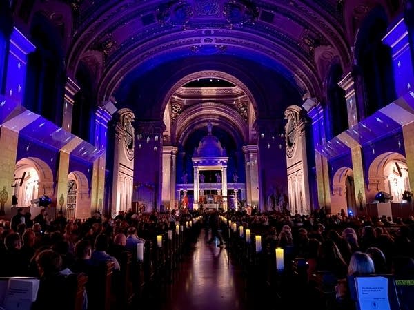 A view of a large cathedral in multicolored lights.