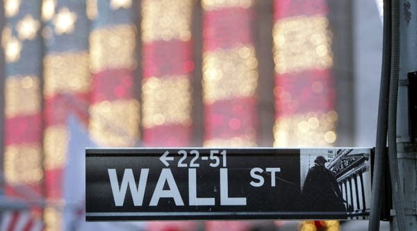 A Wall Street sign in front of the New York Stock Exchange.