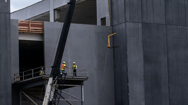 Above, a construction crew works on a data center in Ashburn, Virginia. Wage increases and job demand in fields related to the AI boom are currently strong.