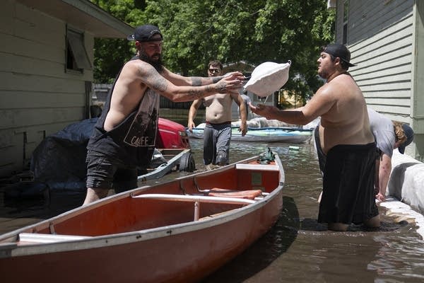 A person tosses a sandbag