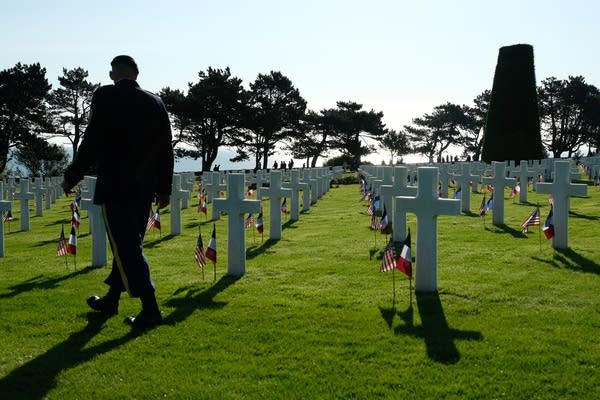 Command Sgt. Maj. Bryan Barker walks among graves.