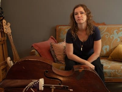 Liz Draper seated on couch in living room.