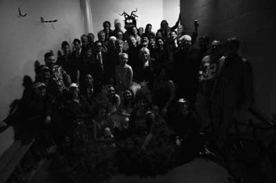 a large band and performers posing for a photo