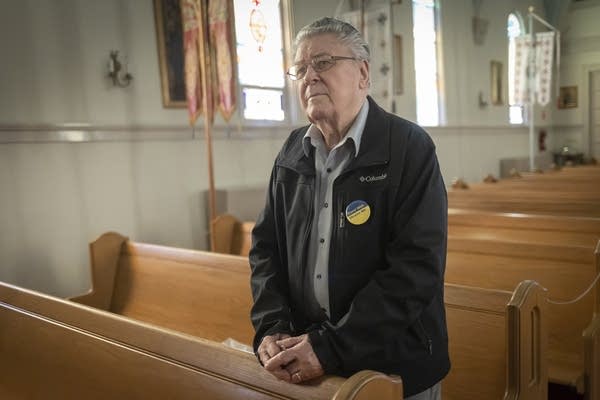 A man stands in a church.