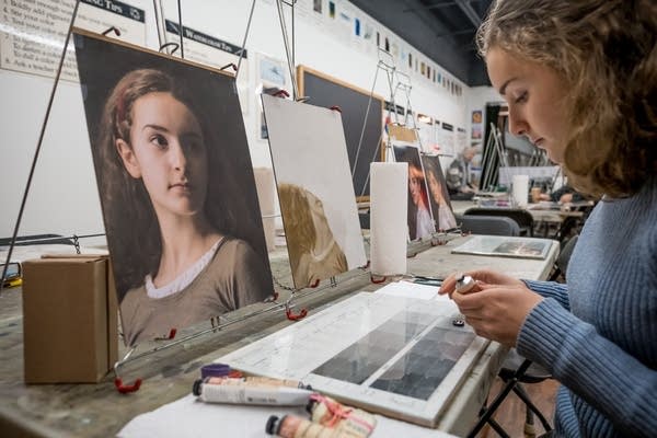 Fina Mooney, 14, of Minneapolis, sets up her supplies to paint.