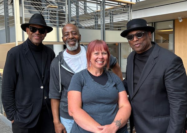 Four people pose for a photo together
