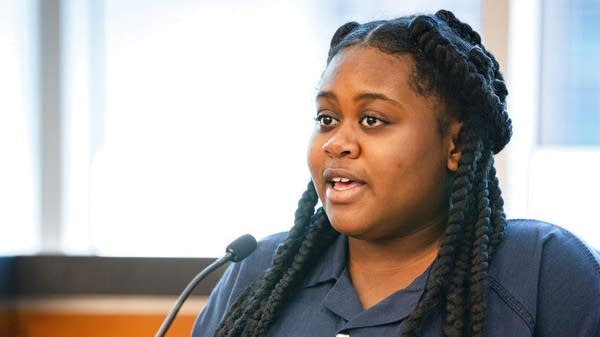 Woman speaks into mic