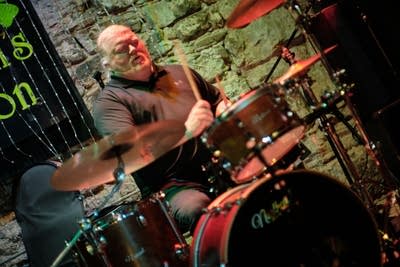 A musician plays drums onstage