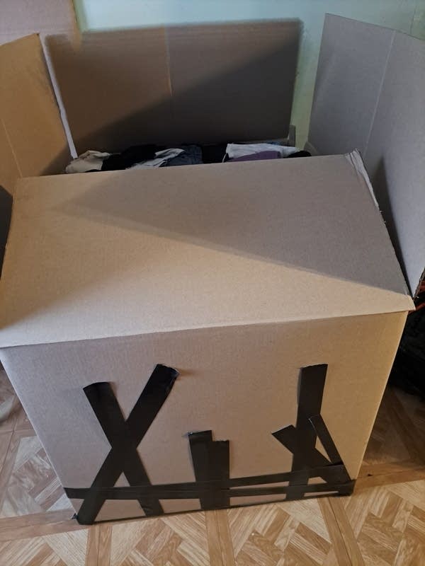 A box is full of items, ready to be taped closed.