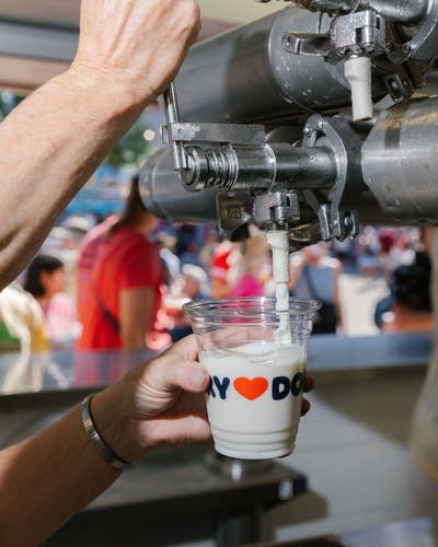 A person pours milk