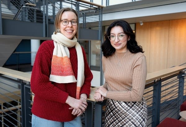 two women pose for a portrait