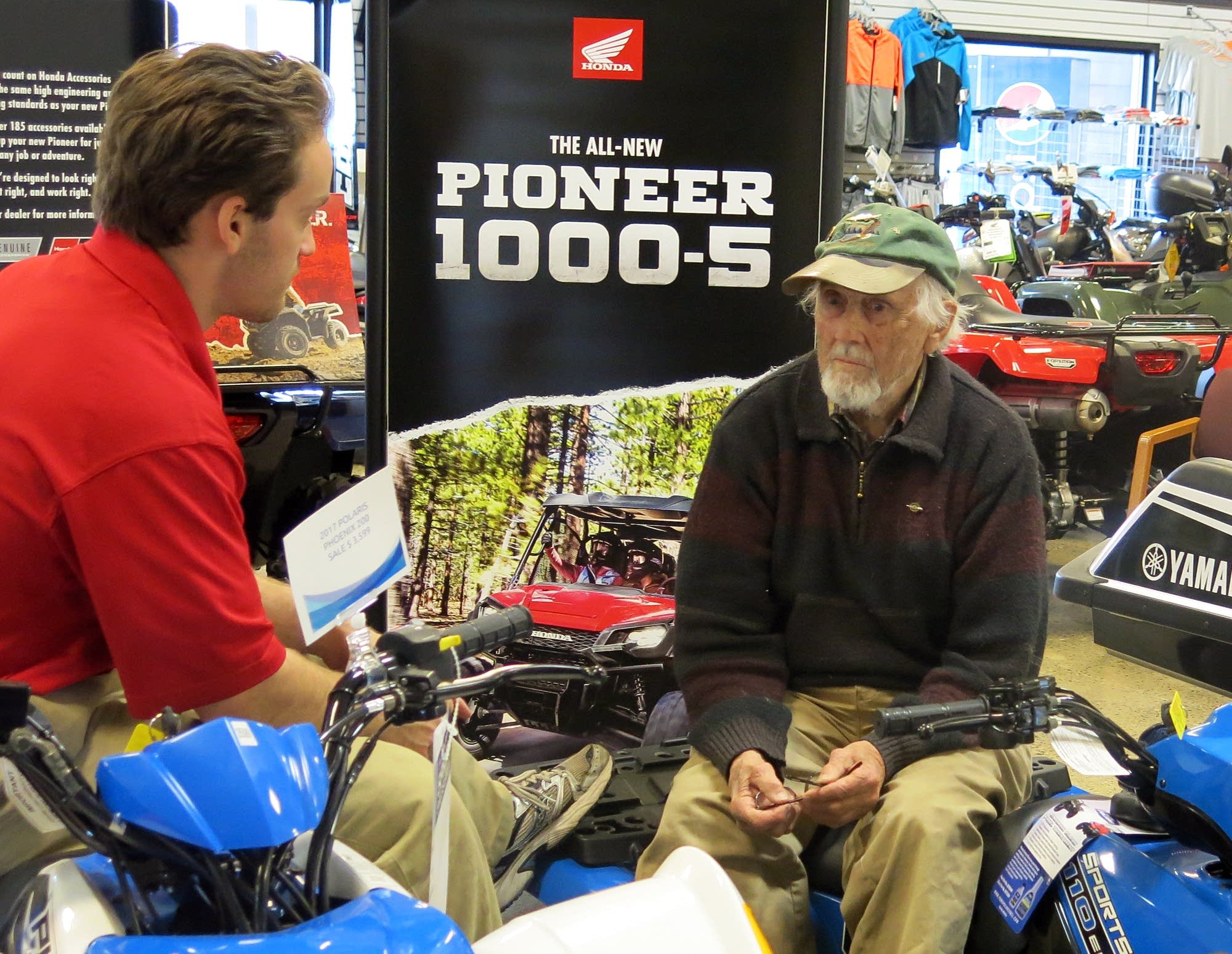 Carl Seemann talks with salesman John Frank at Bemidji Sports Center.