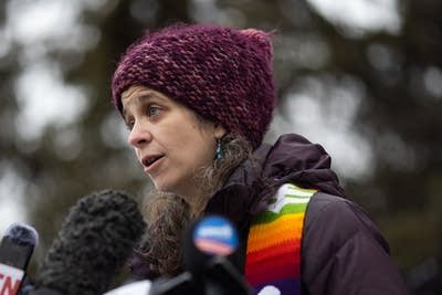 A woman speaks during a presser