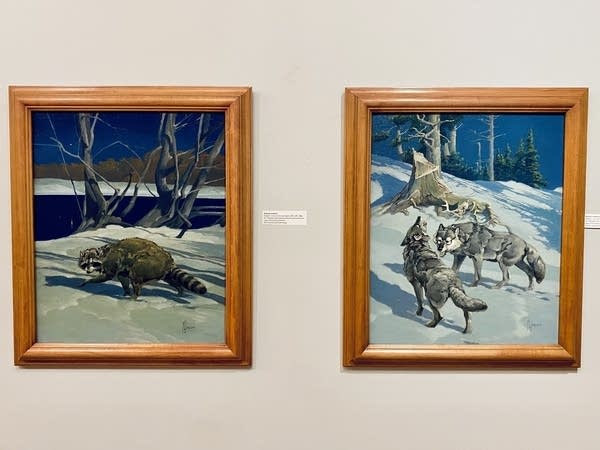 Two paintings side-by-side of a forest in winter. One features a raccoon and the other features wolves.