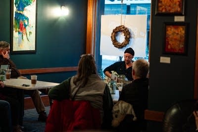 A musician plays guitar in a coffeehouse