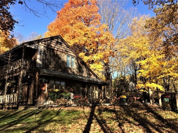 a folk school building under fall foliage