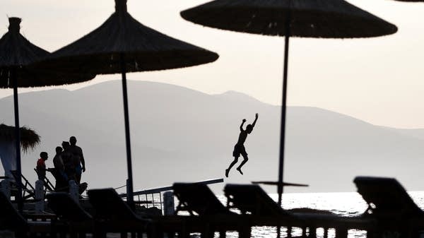 Above, a sandy resort beach on the Adriatic Sea near Vlora, Albania.