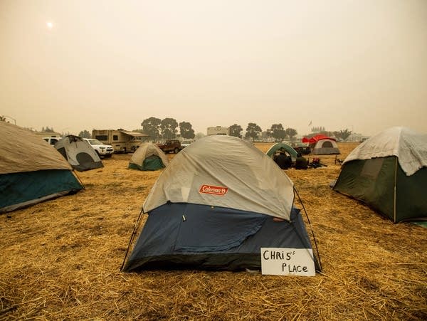 Hundreds missing in fire's wake ahead of Trump visit