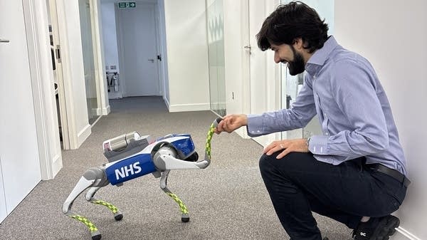Hammad Jeilani, co-founder of the healthcare logistics company Apian, with a “robot dog” named Clive. 
