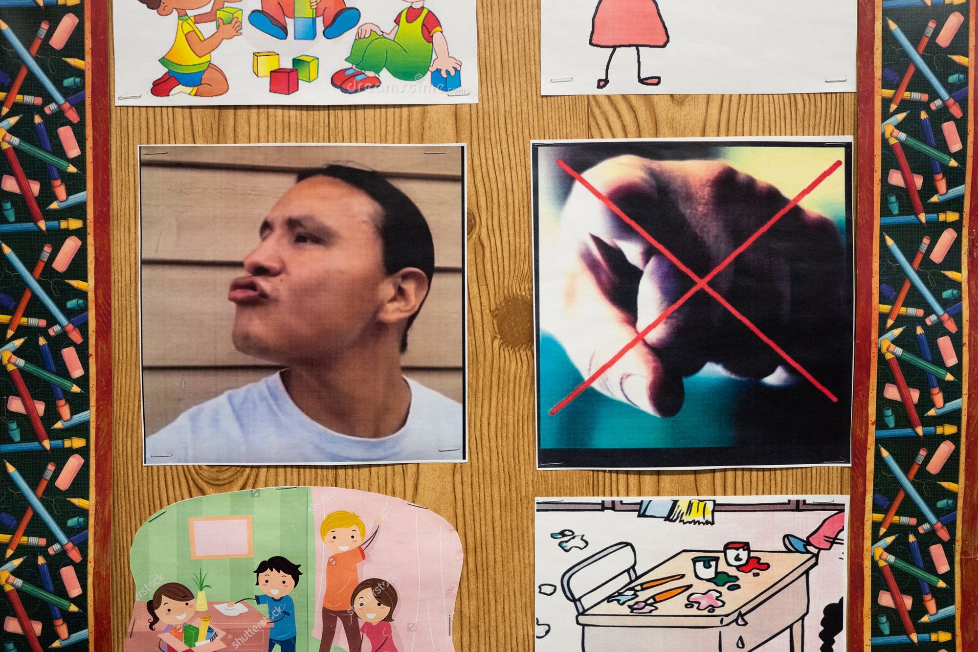 Basic classroom rules hang on the wall