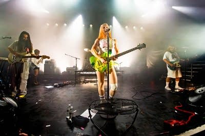 A band performing onstage in a music venue