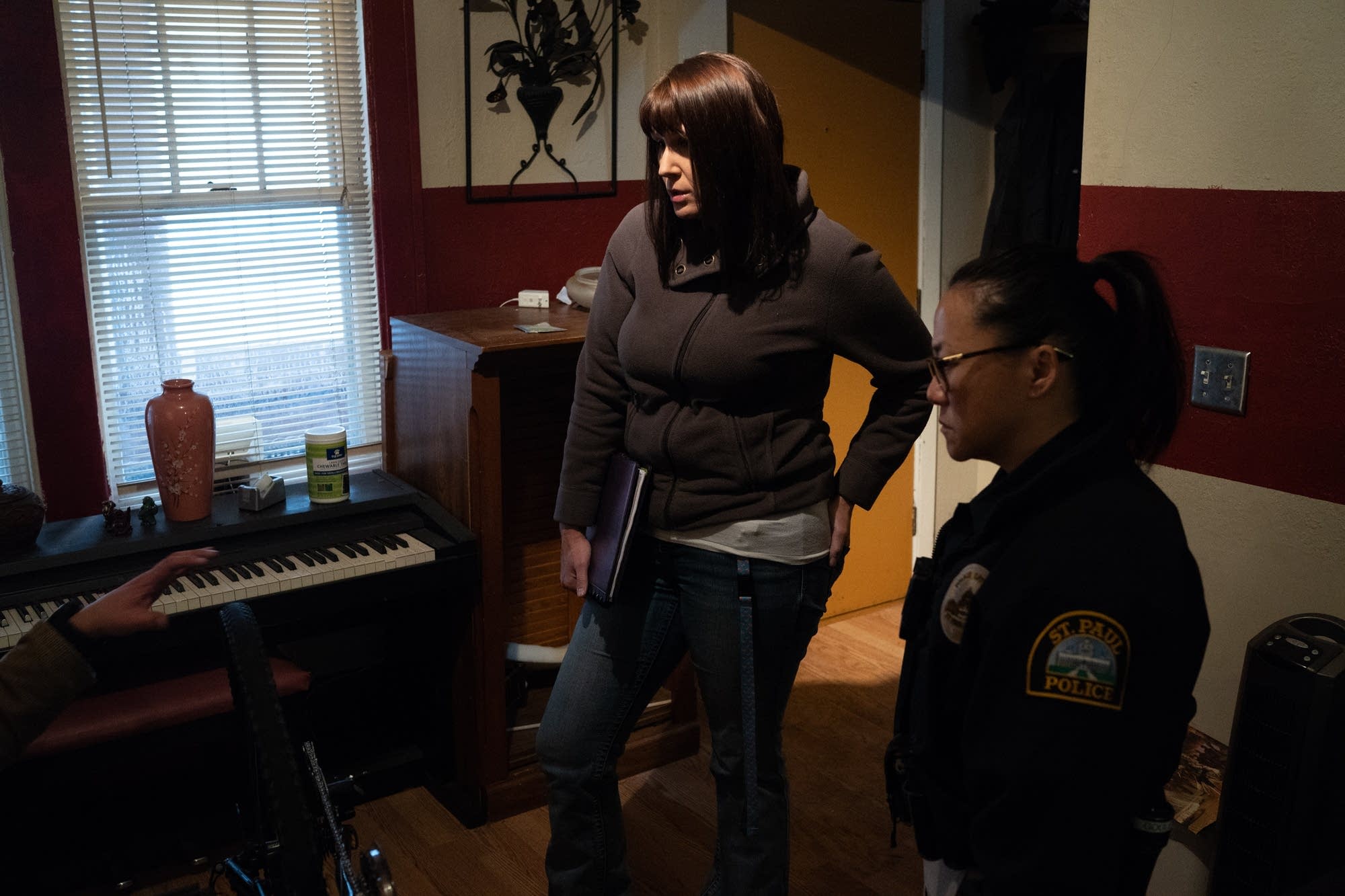 Social worker Amber Ruth and officer Lori Goulet consult a person.