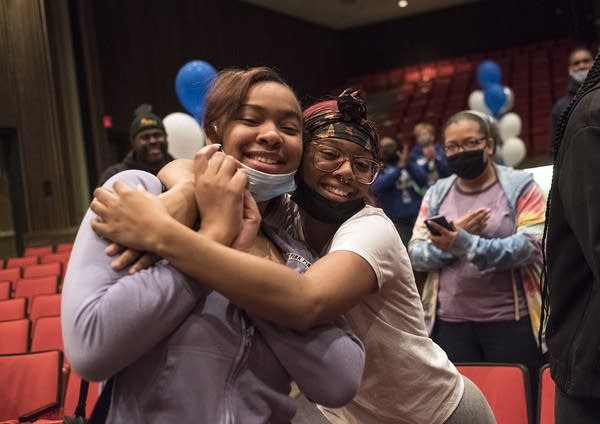 Two people hug and pose for a photo.