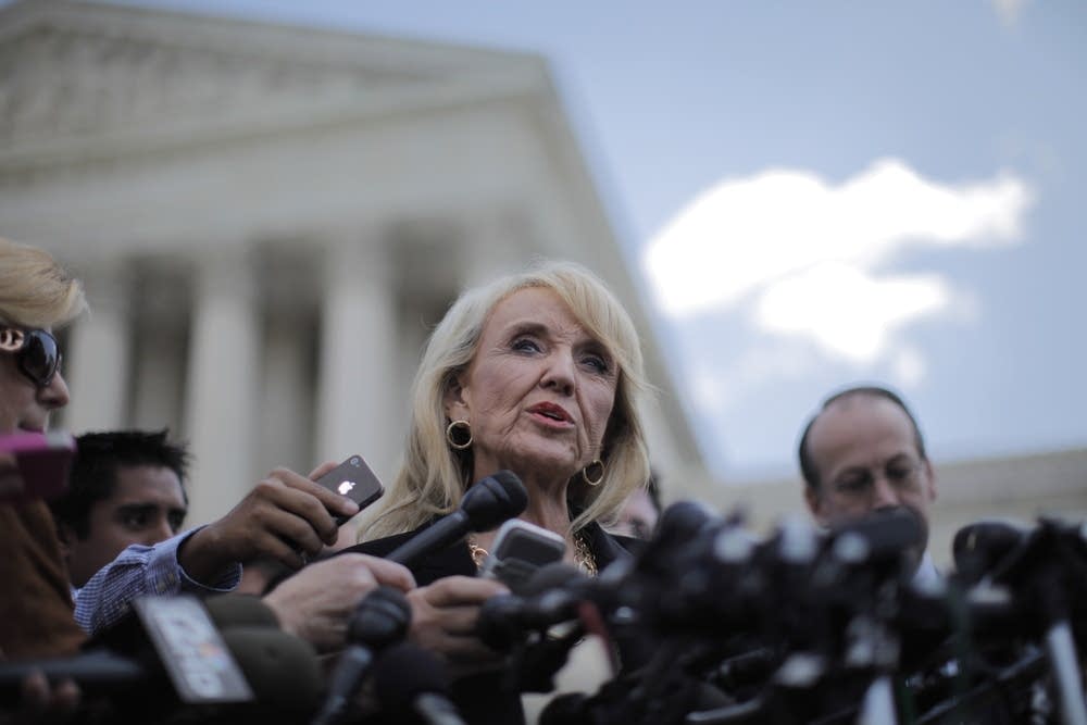 Jan Brewer outside the Supreme Court