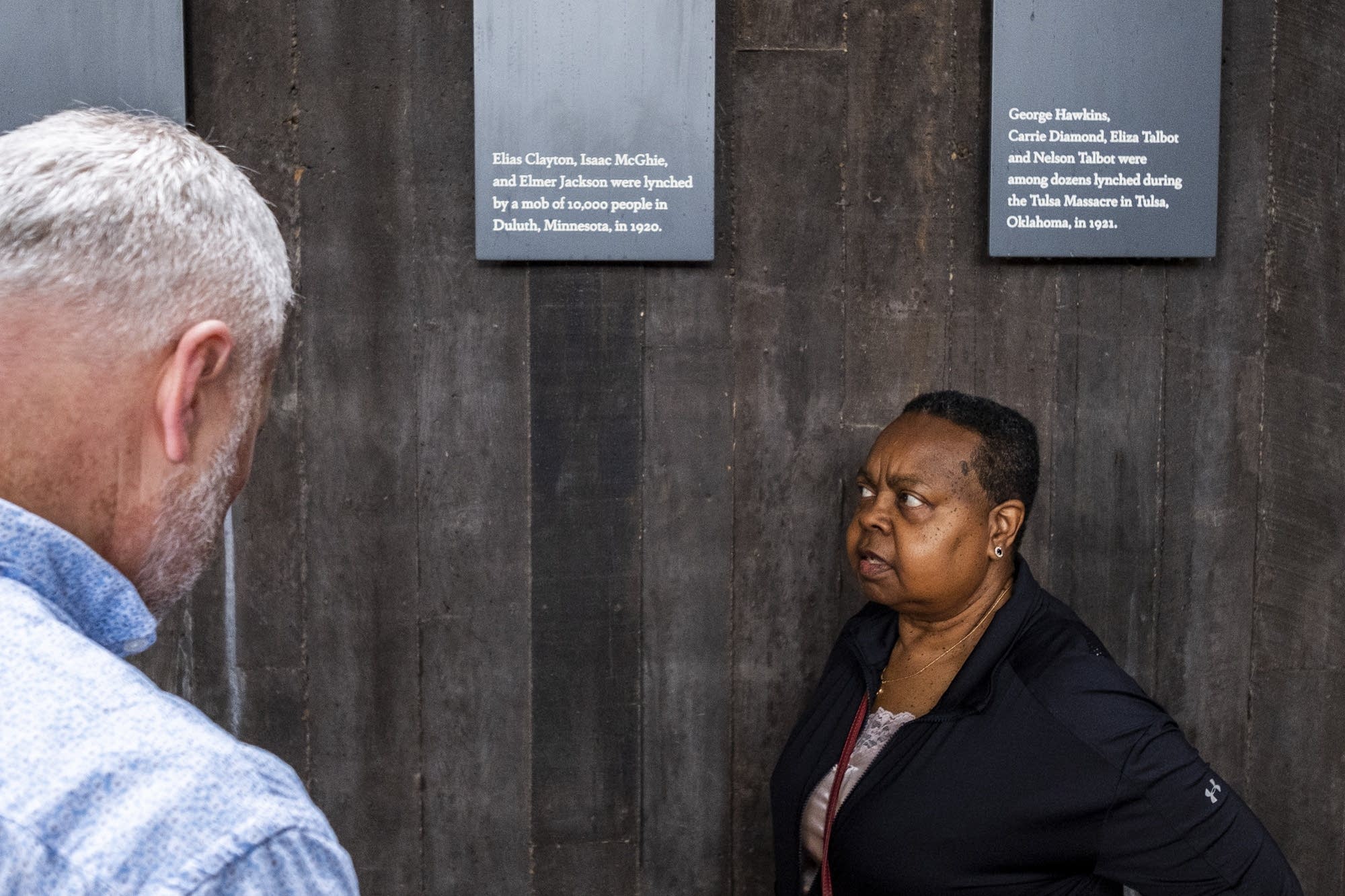 Virginia Huston and Warren Read stop to read a plaque.