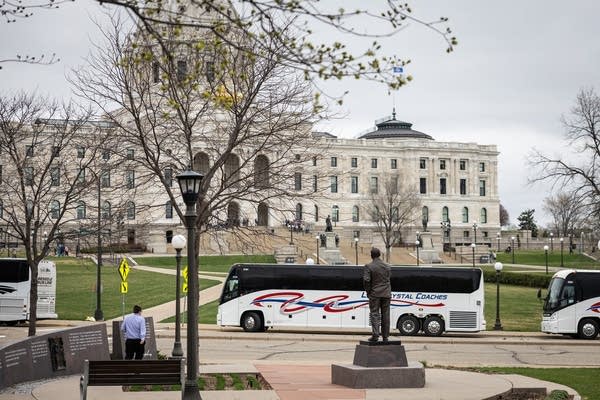 A tall brown statue of a standing man