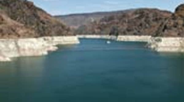 Lake Mead supplies Las Vegas, Arizona and Southern California. Mineral deposits leave a white "bathtub ring" on the rocks, marking areas once submerged under water.