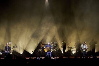 Mumford & Sons performing on stage