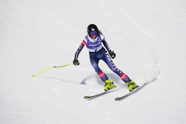 A Paralympics Alpine skier carves down a mountain.