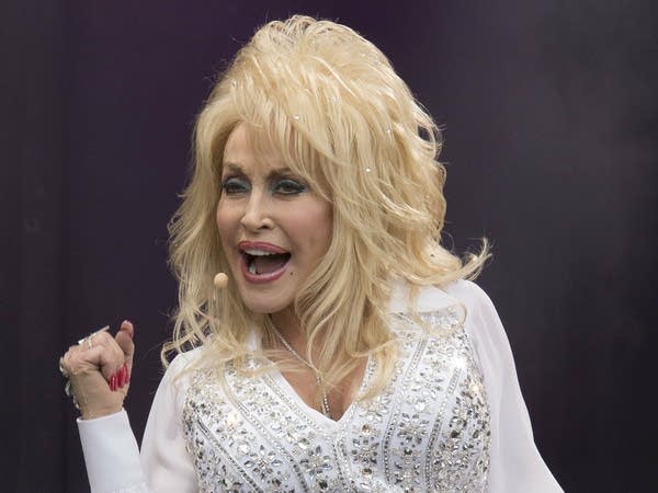 Dolly Parton performs at the Glastonbury music festival in 2014. The parent company of the Dollywood resort will offer its employees free tuition.