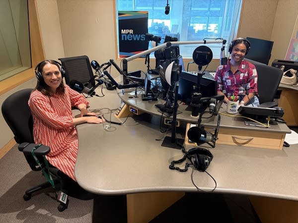 two women smiling in a broadcast studio
