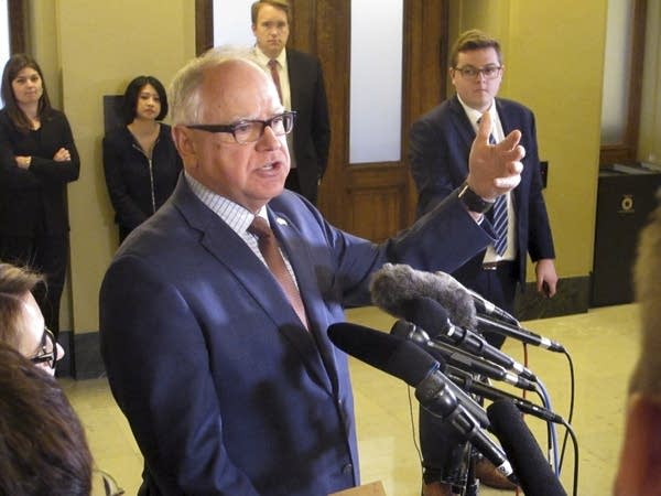 Minnesota Gov. Tim Walz speaks with reporters at the state Capitol.