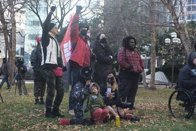 a group of people with megaphones and fists in the air