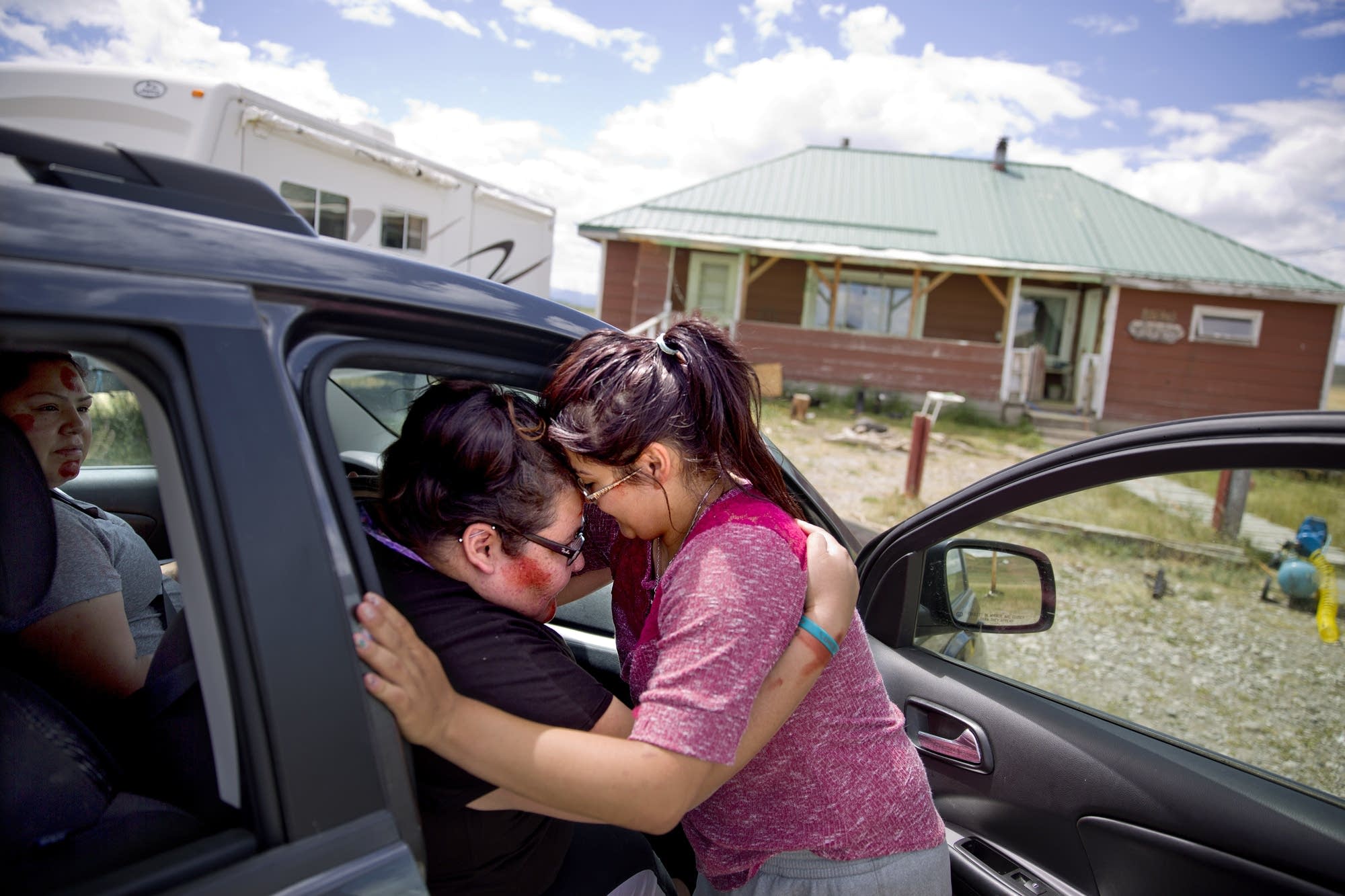 Kimberly Loring, left, touches her forehead to her little sister, Jonnilyn.