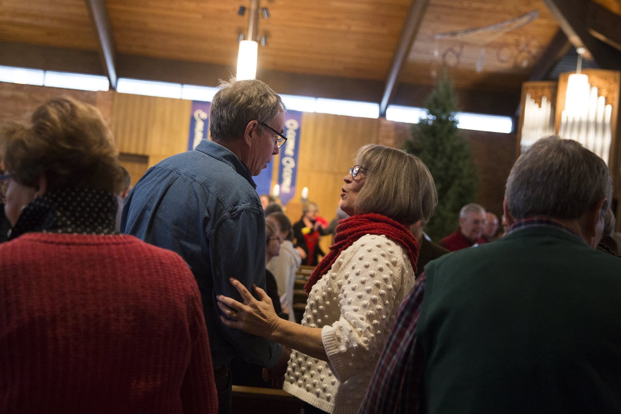 Parishioners greet each other at the beginning of services.