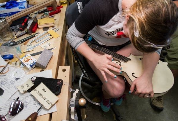 Shaping the edges of a mandolin.