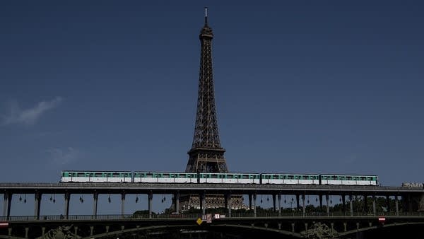 An aerial metro rides as participants compete in a stand-up paddle rally organised by the National Society of Sea Rescue (SNSM) on the Seine river with the Eiffel tower in the background in Paris on June 28, 2019 during the national day of of the Sea Rescuers.