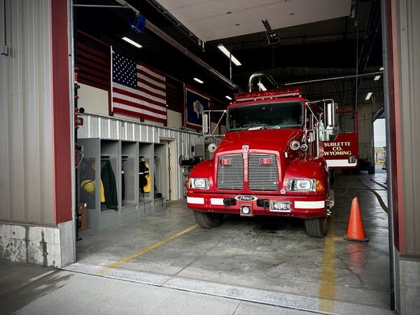 A red fire truck inside a garage.