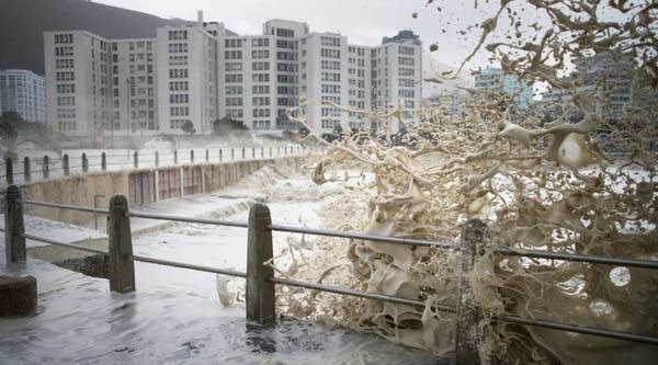 Waves of foam and seawater crash into Three Anchor Bay in Cape Town as an intense storm hits South Africa's west coast.