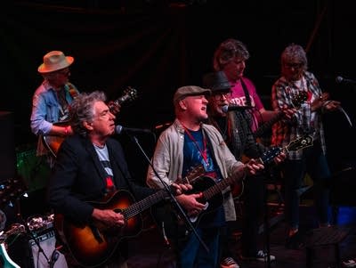 A group of musicians perform onstage.