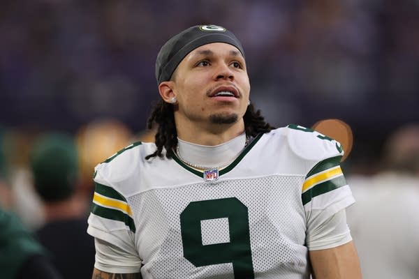 Green Bay Packers wide receiver Christian Watson looks on