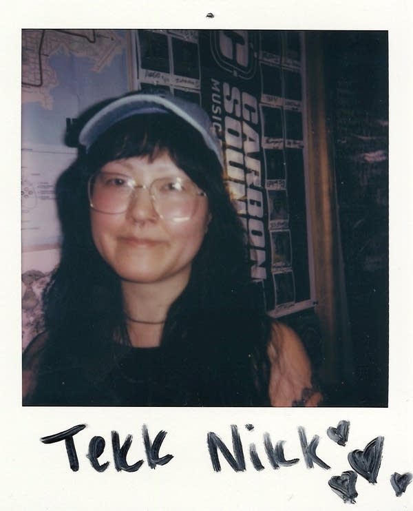 Woman with glasses and baseball cap in Polaroid photo