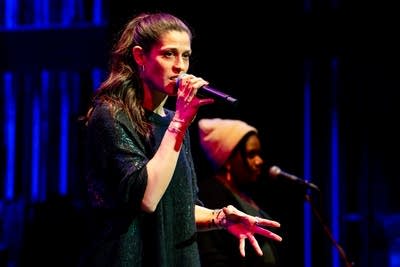 a woman singing on stage